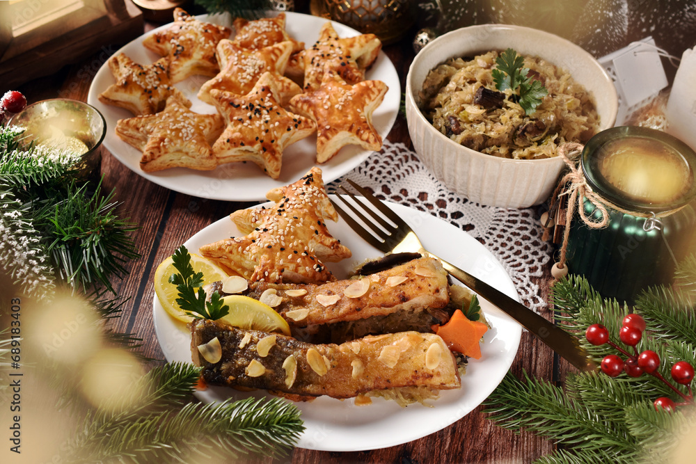 Fried carp with sauerkraut and puff pastry pies filled with mushrooms for Christmas Eve supper in Poland Fried carp with sauerkraut and puff pastry pies filled with mushrooms for Christmas Eve supper in Poland