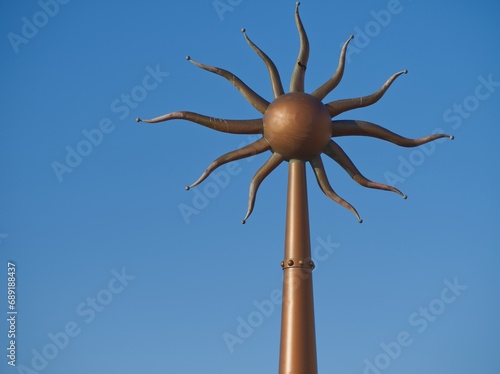 Bronze Sun Symbol installation blue sky bronze Southport UK 