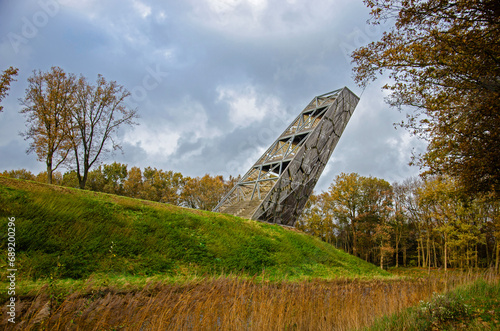 Halsteren, The Netherlands, November 19, 2023: wooden observation tower, leaning towards the moat around the former defense structure of Fort de Roovere photo