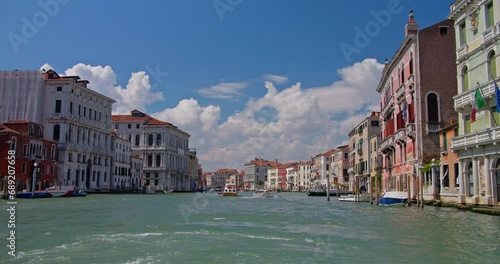 Sweeping view of the Grand Canal with vibrant Venetian palazzos and bustling boat activity under a picturesque sky, encapsulating the spirit of Venice. photo