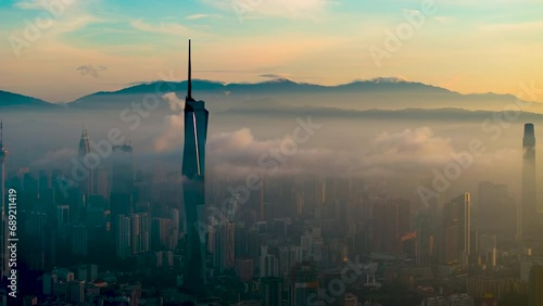 An establish aerial hyperlapse shot of Kuala Lumpur city overseeing the main four towers skyscrappers during misty morning photo