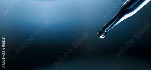 Water droplets macro science experiment,Liquid drop from laboratory glass Pipette photo