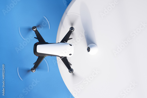 Advanced White Quadcopter Drone Soaring Against a Blue Sky Background photo