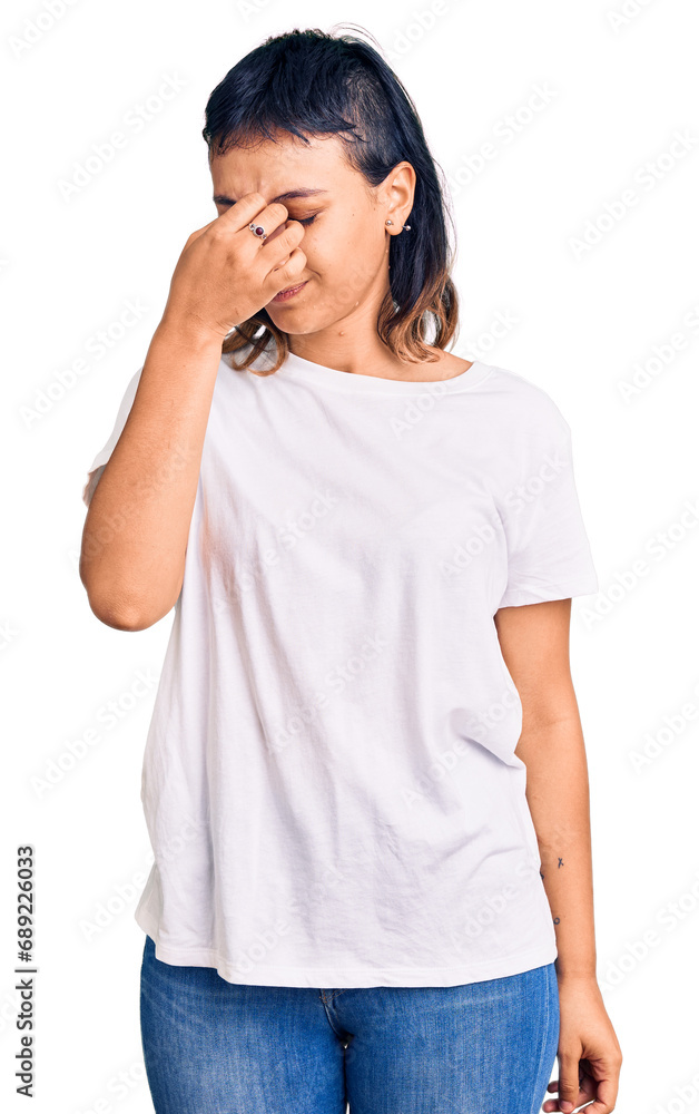 Young woman wearing casual clothes tired rubbing nose and eyes feeling fatigue and headache. stress and frustration concept. Young woman wearing casual clothes tired rubbing nose and eyes feeling fatigue and headache. stress and frustration concept.