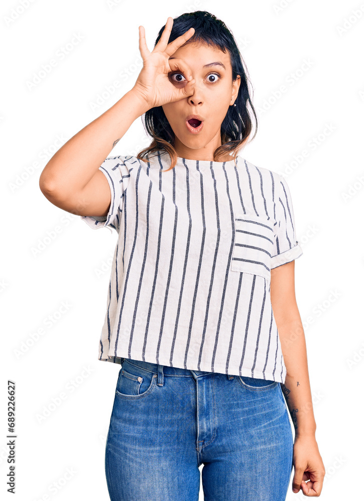 Young woman wearing casual clothes doing ok gesture shocked with surprised face, eye looking through fingers. unbelieving expression. Young woman wearing casual clothes doing ok gesture shocked with surprised face, eye looking through fingers. unbelieving expression.