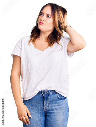 Young beautiful caucasian woman wearing casual white tshirt confuse and wondering about question. uncertain with doubt, thinking with hand on head. pensive concept.