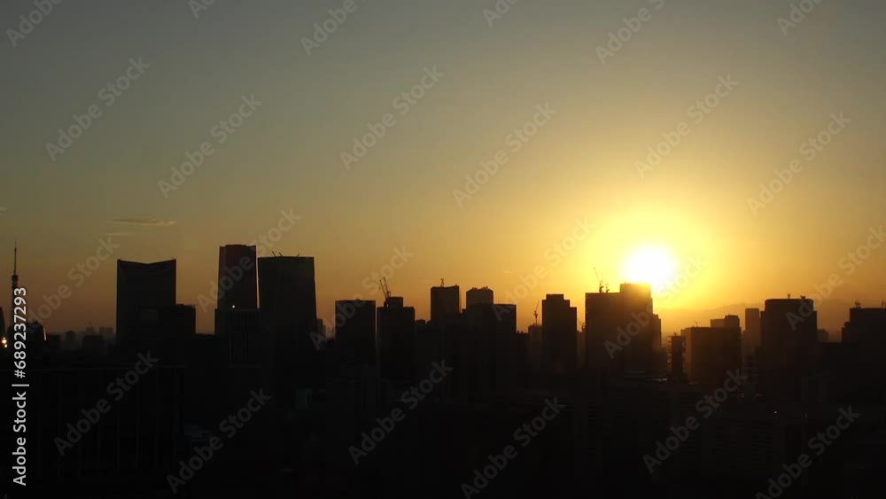 TOKYO, JAPAN - NOV 2023 : Aerial high angle view of cityscape of Tokyo and Mount Fuji in sunset. View of office buildings around Tokyo station and Nagatacho area. 4K time lapse shot, day to night. TOKYO, JAPAN - NOV 2023 : Aerial high angle view of cityscape of Tokyo and Mount Fuji in sunset. View of office buildings around Tokyo station and Nagatacho area. 4K time lapse shot, day to night.