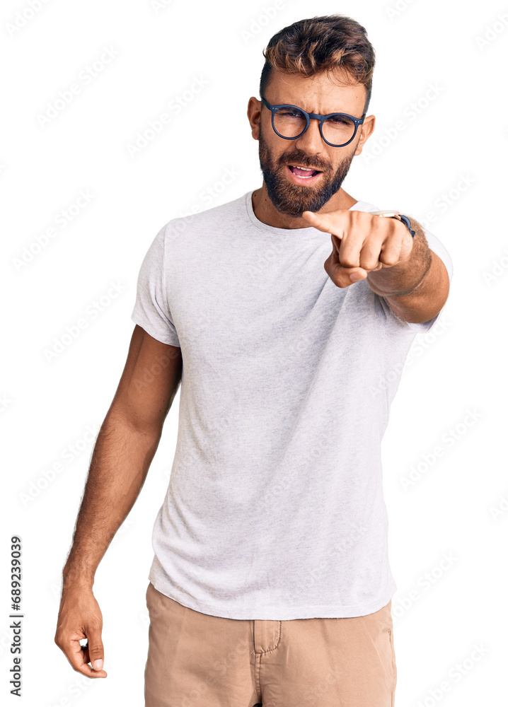 Young hispanic man wearing casual clothes and glasses pointing displeased and frustrated to the camera, angry and furious with you Young hispanic man wearing casual clothes and glasses pointing displeased and frustrated to the camera, angry and furious with you