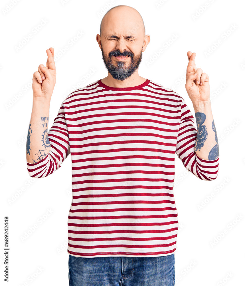 Young handsome man wearing casual clothes gesturing finger crossed smiling with hope and eyes closed. luck and superstitious concept. Young handsome man wearing casual clothes gesturing finger crossed smiling with hope and eyes closed. luck and superstitious concept.