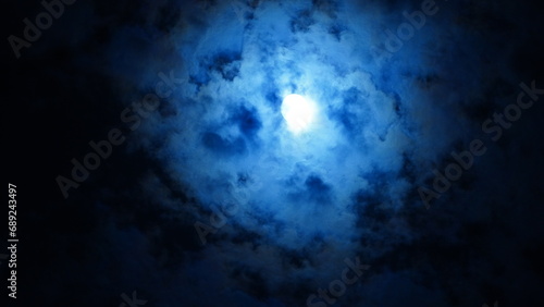 The moon night view with the full moon and clouds in the sky