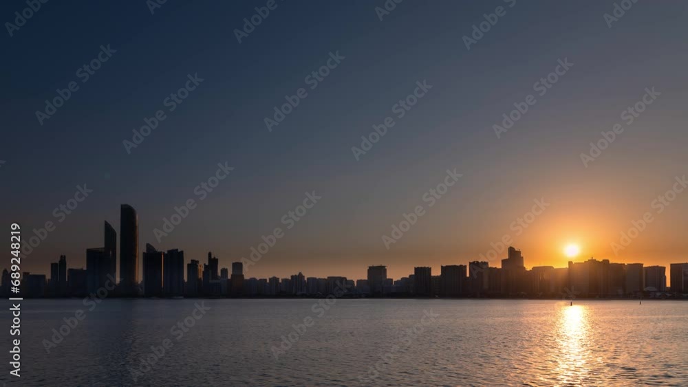 Time Lapse of sunrise motion overlooking city scape, people relaxing in the capital city of Abu Dhabi Time Lapse of sunrise motion overlooking city scape, people relaxing in the capital city of Abu Dhabi