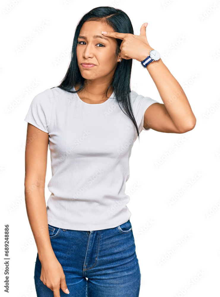 Beautiful hispanic woman wearing casual white tshirt pointing unhappy to pimple on forehead, ugly infection of blackhead. acne and skin problem Beautiful hispanic woman wearing casual white tshirt pointing unhappy to pimple on forehead, ugly infection of blackhead. acne and skin problem