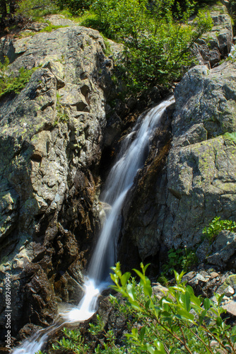 waterfall in the mountains with trees