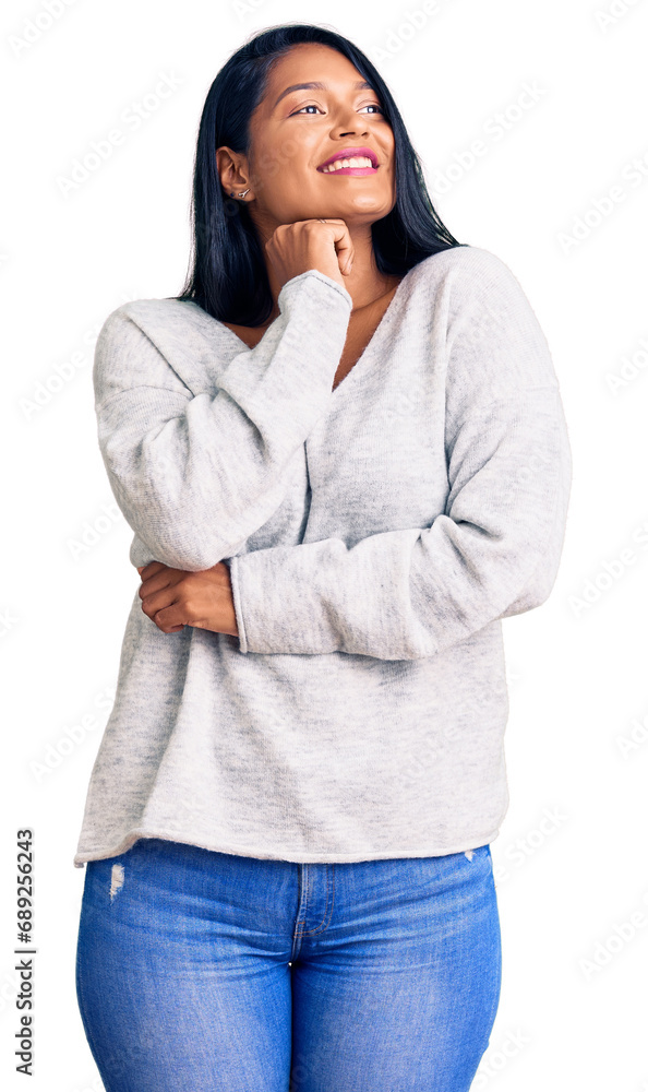 Hispanic woman with long hair wearing casual clothes with hand on chin thinking about question, pensive expression. smiling and thoughtful face. doubt concept. Hispanic woman with long hair wearing casual clothes with hand on chin thinking about question, pensive expression. smiling and thoughtful face. doubt concept.
