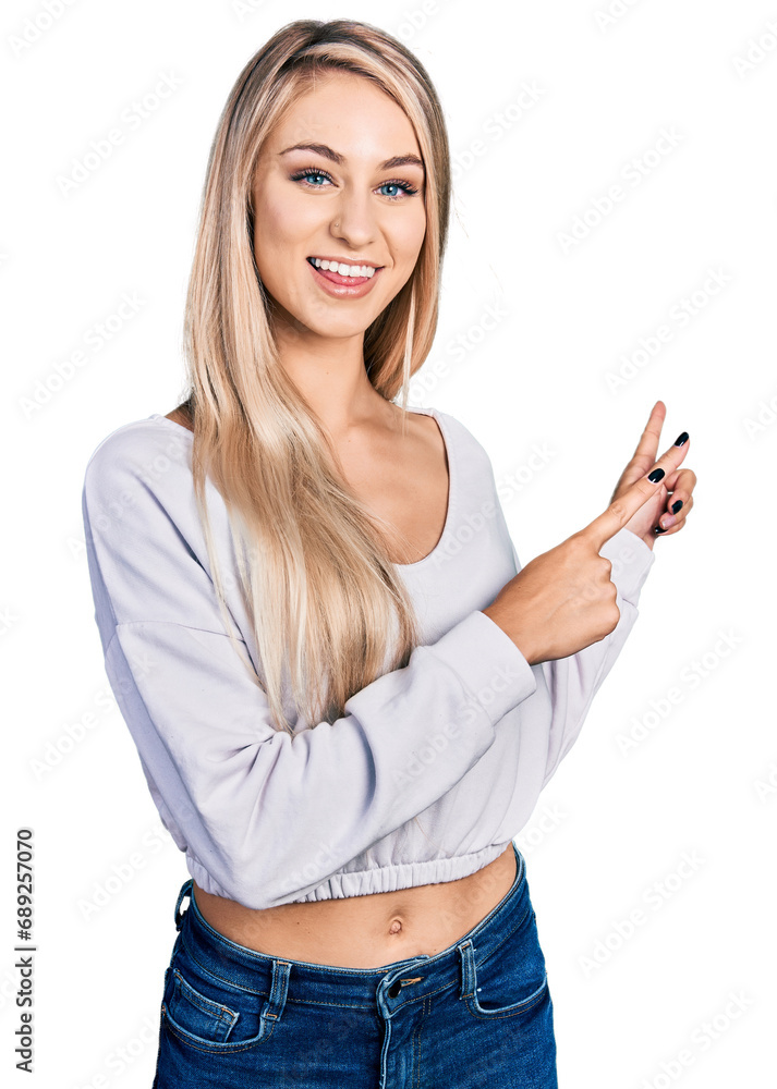 Beautiful young blonde woman wearing casual white sweater smiling and looking at the camera pointing with two hands and fingers to the side. Beautiful young blonde woman wearing casual white sweater smiling and looking at the camera pointing with two hands and fingers to the side.