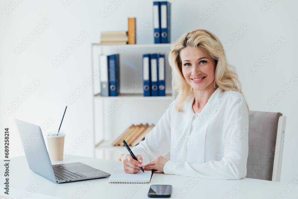 Woman in office at laptop small business online Woman in office at laptop small business online