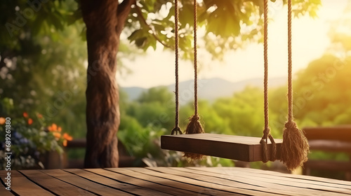 old wooden terrace with wicker swing hang on the tree . photo