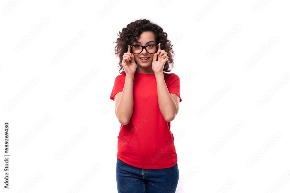 corporate clothing concept. young charming curly brunette woman dressed in red clothes on a white background with copy space corporate clothing concept. young charming curly brunette woman dressed in red clothes on a white background with copy space