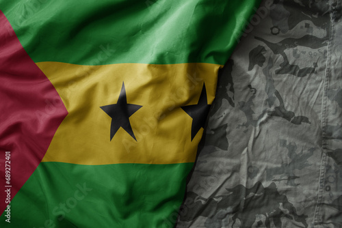 waving flag of sao tome and principe on the old khaki texture background. military concept.
