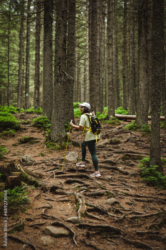 Woman in the middle of the forest with a backpack Woman in the middle of the forest with a backpack