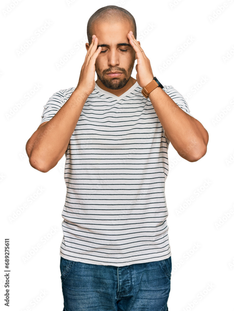 Hispanic adult man wearing casual clothes with hand on head for pain in head because stress. suffering migraine. Hispanic adult man wearing casual clothes with hand on head for pain in head because stress. suffering migraine.