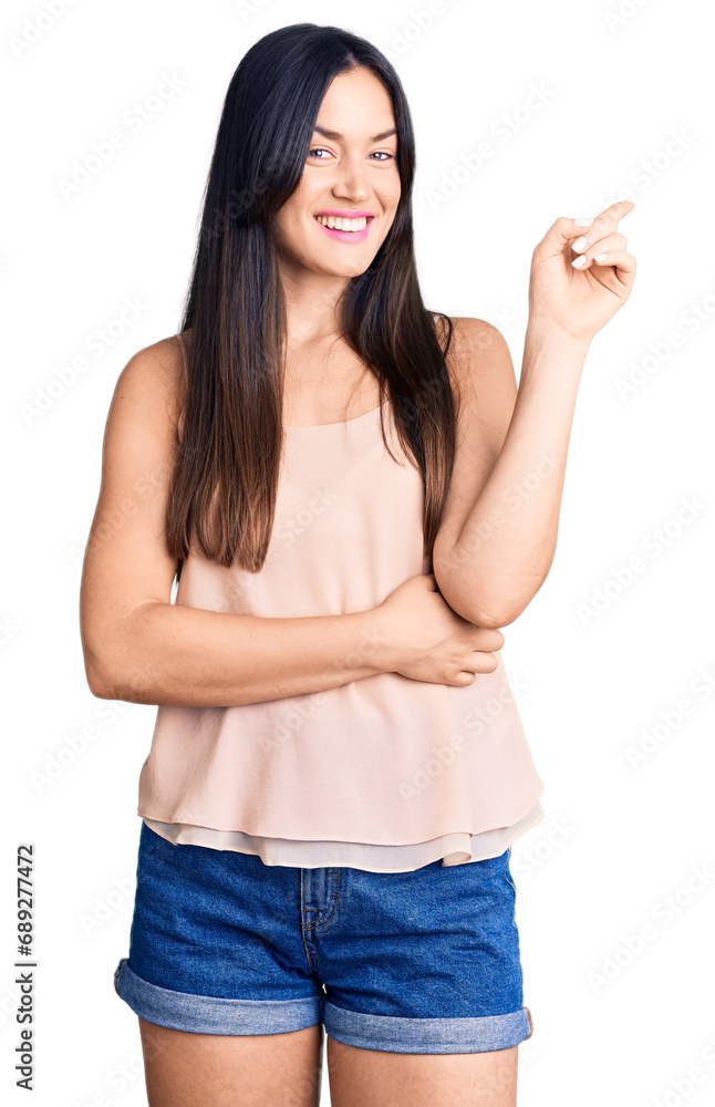 Young beautiful caucasian woman wearing casual clothes smiling happy pointing with hand and finger to the side Young beautiful caucasian woman wearing casual clothes smiling happy pointing with hand and finger to the side