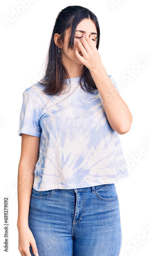 Young beautiful girl wearing casual t shirt tired rubbing nose and eyes feeling fatigue and headache. stress and frustration concept.