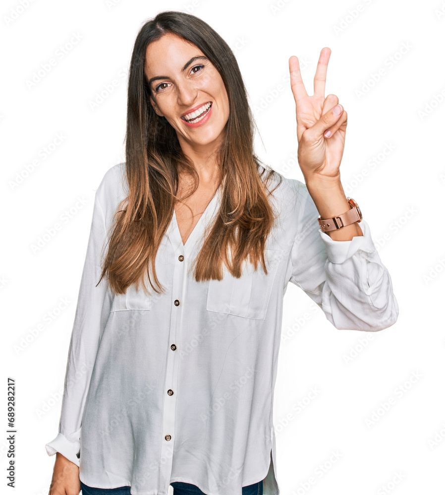 Young beautiful woman wearing casual clothes smiling looking to the camera showing fingers doing victory sign. number two. Young beautiful woman wearing casual clothes smiling looking to the camera showing fingers doing victory sign. number two.