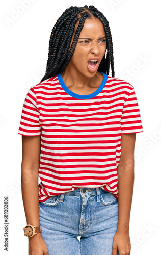 Beautiful hispanic woman wearing casual clothes angry and mad screaming frustrated and furious, shouting with anger. rage and aggressive concept.