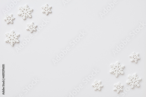 Festive arrangement made of snowflakes on a white background. Flat lay, top view, copy space.