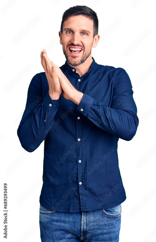 Young handsome man wearing casual shirt clapping and applauding happy and joyful, smiling proud hands together Young handsome man wearing casual shirt clapping and applauding happy and joyful, smiling proud hands together