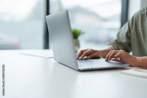 Businesswoman using laptop with technology to typing and working about calculation tax in office