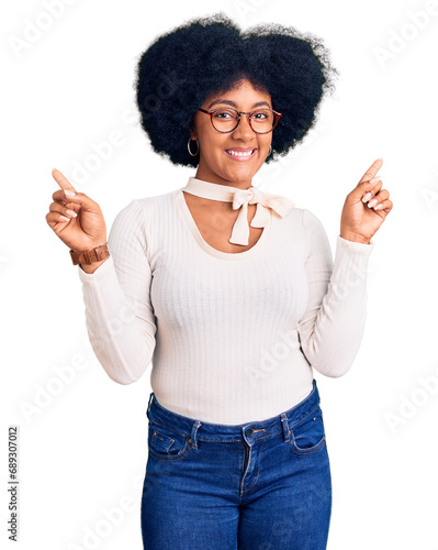 Young african american girl wearing casual clothes and glasses smiling confident pointing with fingers to different directions. copy space for advertisement