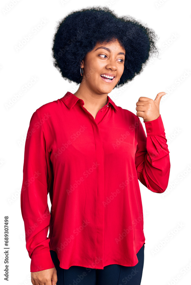 Young african american girl wearing casual clothes smiling with happy face looking and pointing to the side with thumb up. Young african american girl wearing casual clothes smiling with happy face looking and pointing to the side with thumb up.