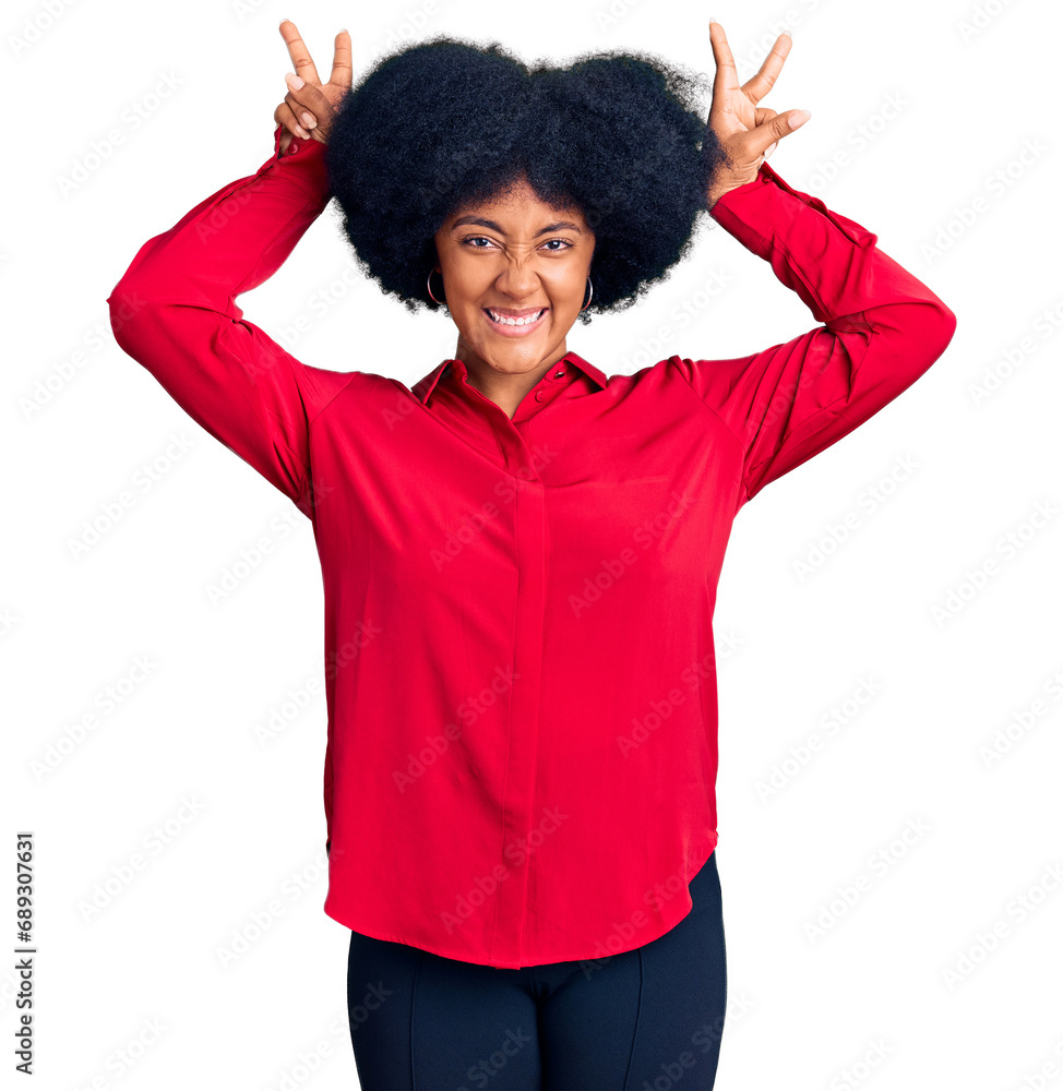 Young african american girl wearing casual clothes posing funny and crazy with fingers on head as bunny ears, smiling cheerful Young african american girl wearing casual clothes posing funny and crazy with fingers on head as bunny ears, smiling cheerful