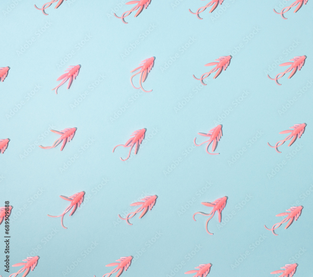 Pattern of pink bugs on blue background. Pastel, natural concept. Fishing lures. Pattern of pink bugs on blue background. Pastel, natural concept. Fishing lures.