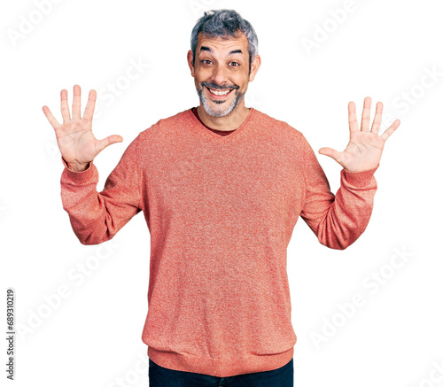 Middle age hispanic with grey hair wearing casual sweater showing and pointing up with fingers number ten while smiling confident and happy.