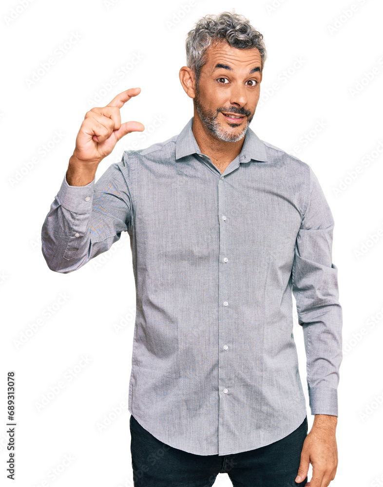 Middle age grey-haired man wearing casual clothes smiling and confident gesturing with hand doing small size sign with fingers looking and the camera. measure concept. Middle age grey-haired man wearing casual clothes smiling and confident gesturing with hand doing small size sign with fingers looking and the camera. measure concept.