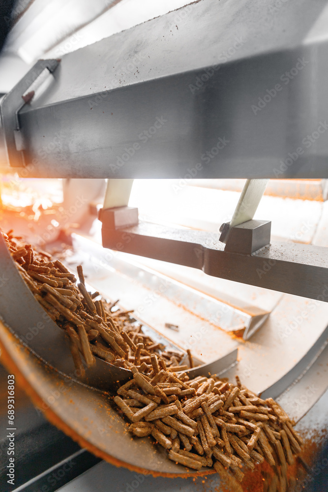 Closeup crunchy bread sticks dried and processed with spices in drum. Food conveyor line at manufacture snack Closeup crunchy bread sticks dried and processed with spices in drum. Food conveyor line at manufacture snack