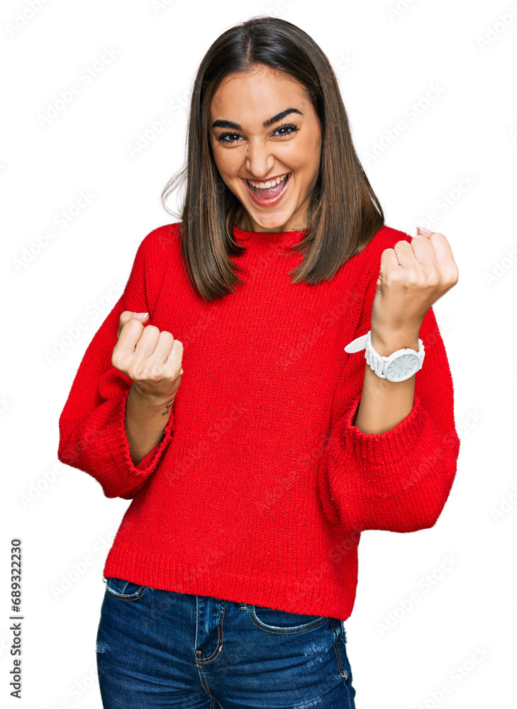 Beautiful brunette woman wearing casual winter sweater celebrating surprised and amazed for success with arms raised and eyes closed. winner concept. Beautiful brunette woman wearing casual winter sweater celebrating surprised and amazed for success with arms raised and eyes closed. winner concept.