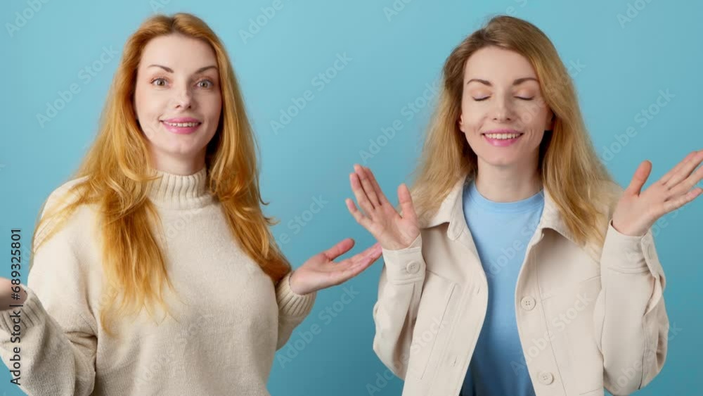 Friends, surprised woman and hands up wonder, shocked. Wow! Two women sister fashionable amazed excited by success, win, surprise emotion. Oh my god expression! Trend makeup, vivid outfit on blue Friends, surprised woman and hands up wonder, shocked. Wow! Two women sister fashionable amazed excited by success, win, surprise emotion. Oh my god expression! Trend makeup, vivid outfit on blue