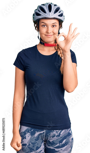 Beautiful caucasian woman wearing bike helmet smiling positive doing ok sign with hand and fingers. successful expression.