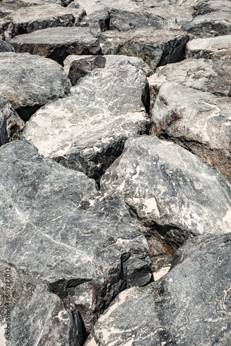 stones boulders are huge piled up in close-up gray
