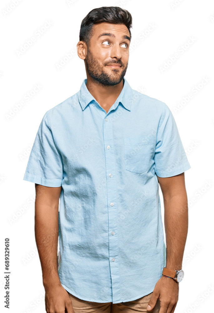 Fototapeta premium Handsome hispanic man wearing casual clothes smiling looking to the side and staring away thinking.