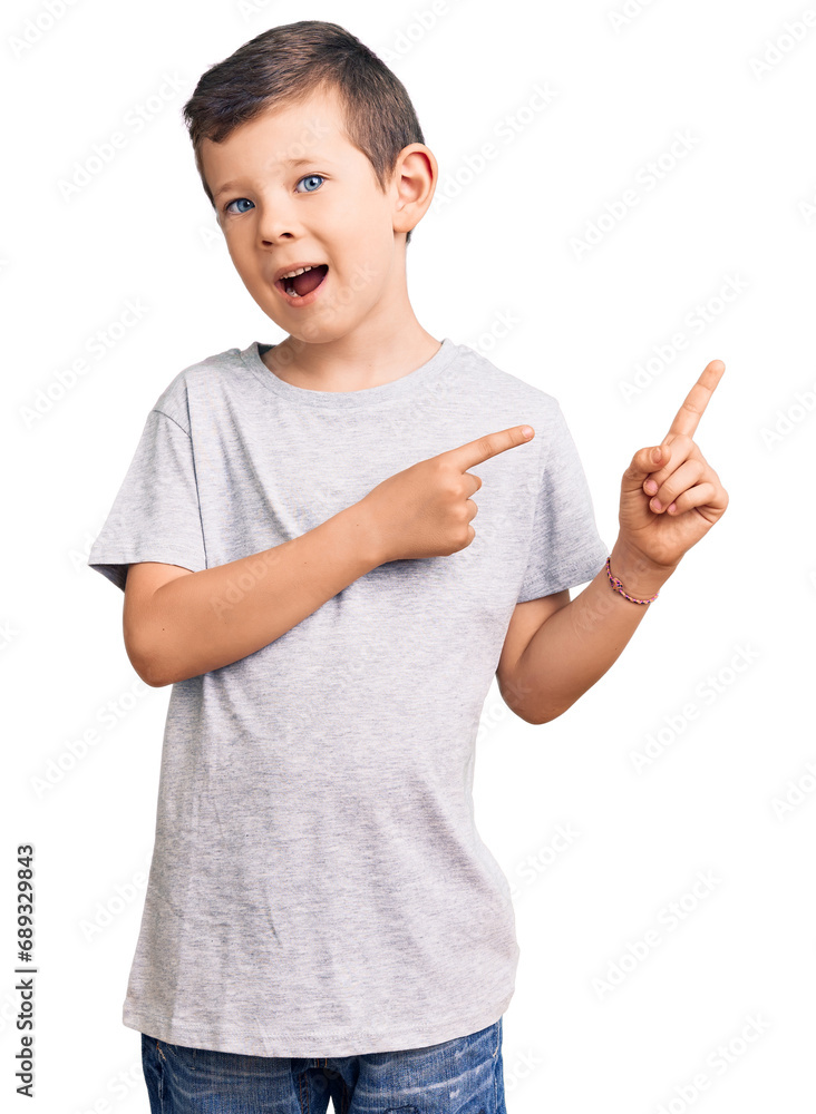 Cute blond kid wearing casual clothes smiling and looking at the camera pointing with two hands and fingers to the side. Cute blond kid wearing casual clothes smiling and looking at the camera pointing with two hands and fingers to the side.