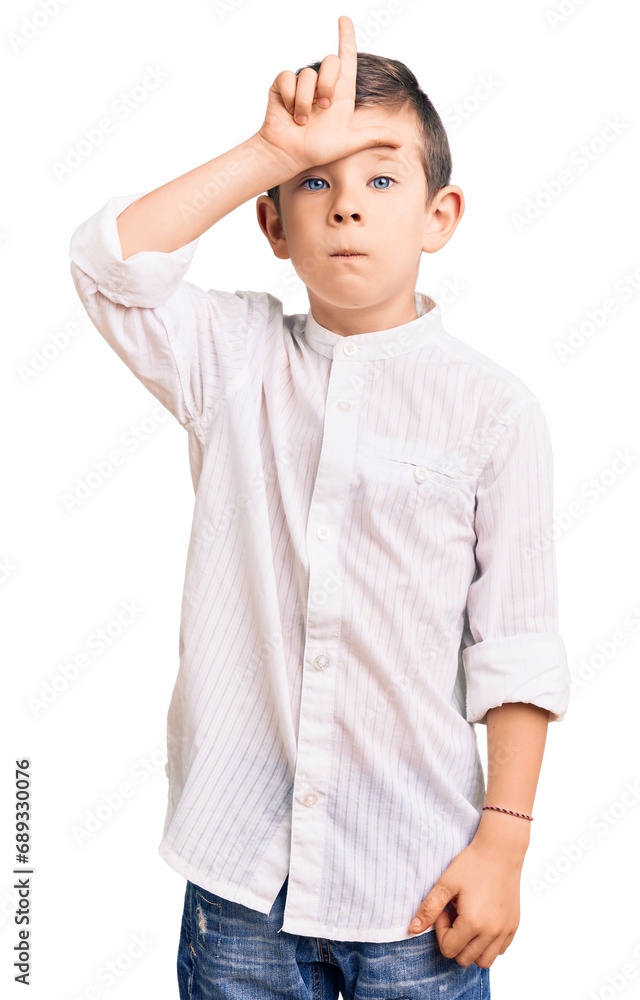 Cute blond kid wearing elegant shirt making fun of people with fingers on forehead doing loser gesture mocking and insulting. Cute blond kid wearing elegant shirt making fun of people with fingers on forehead doing loser gesture mocking and insulting.