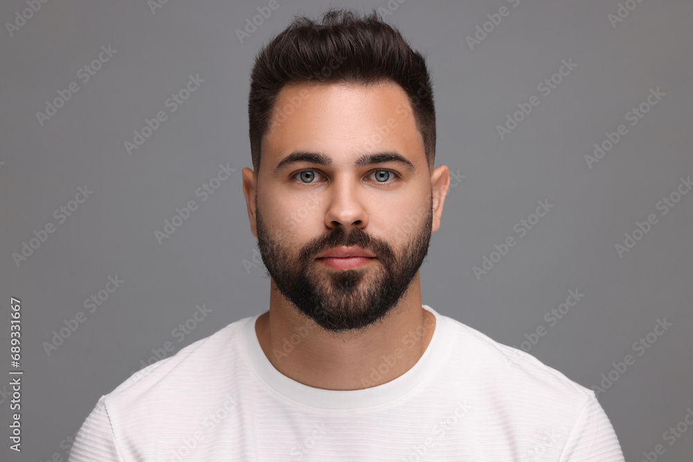 Portrait of young man on light grey background