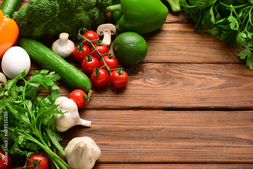 Fresh vegetables  greenery and mushrooms on wooden background