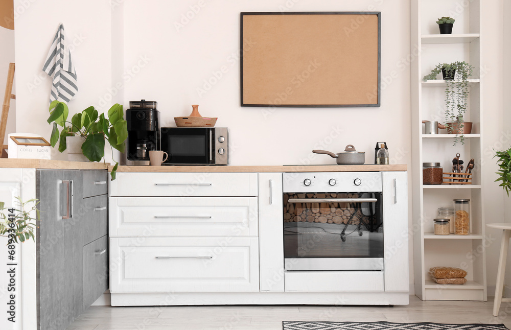 Interior of light kitchen with counters and shelf unit Interior of light kitchen with counters and shelf unit