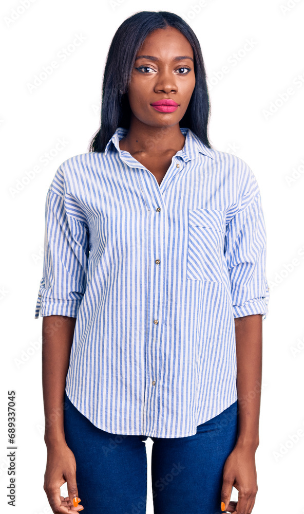 Young african american woman wearing casual clothes relaxed with serious expression on face. simple and natural looking at the camera. Young african american woman wearing casual clothes relaxed with serious expression on face. simple and natural looking at the camera.